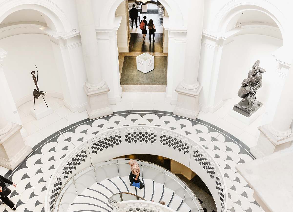 tate britain person walking upstairs inside building staircase